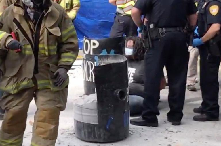 Florida Protester Arrested Outside Governor’s Mansion with Arms Trapped in Concrete Barrel